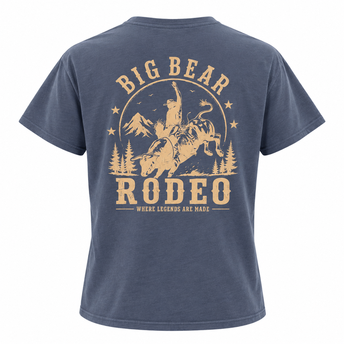 A navy blue short-sleeve t-shirt shown from the back, featuring a large tan graphic print of a cowboy riding a bucking bull with the text 'BIG BEAR RODEO' and 'WHERE LEGENDS ARE MADE'.