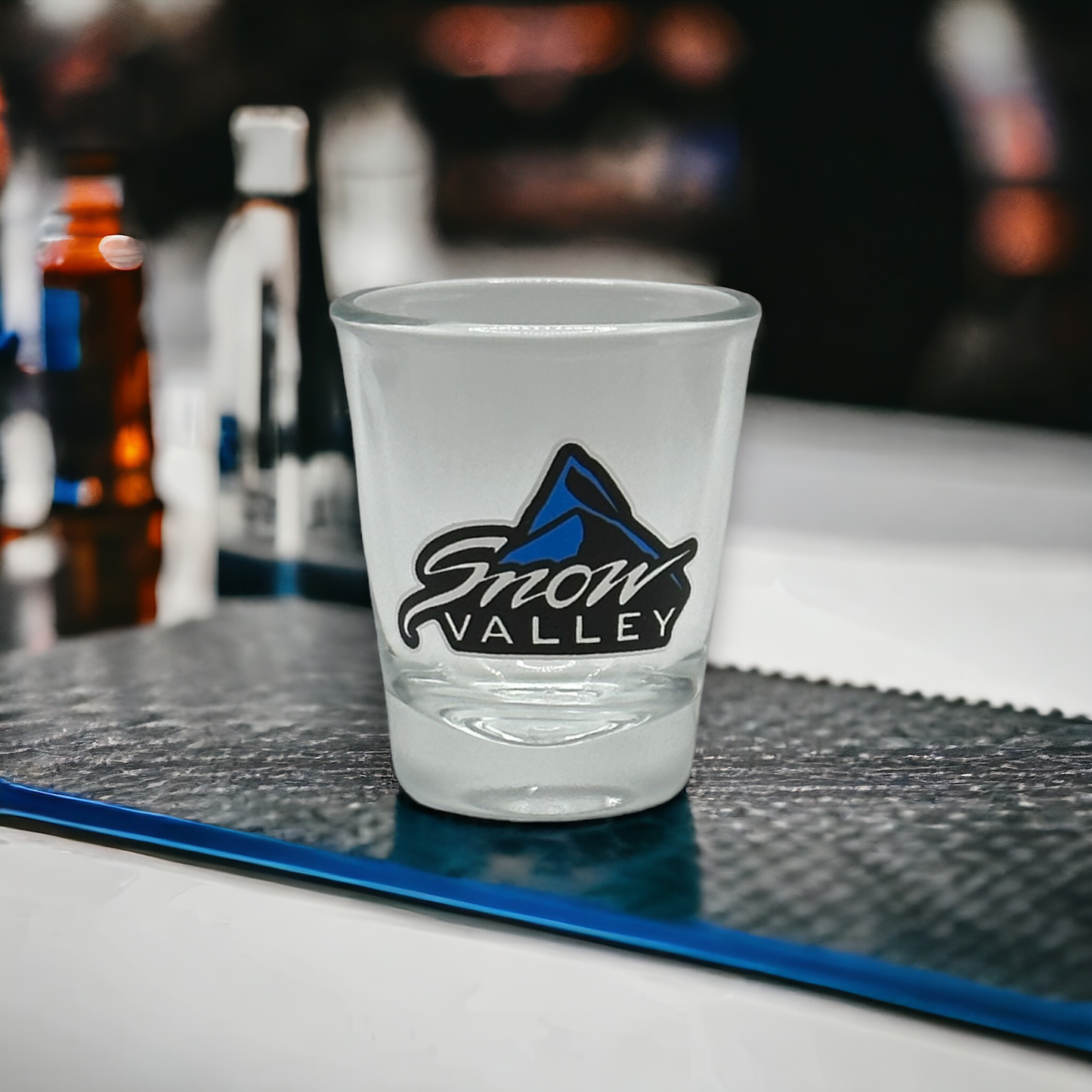 Clear glass shot glass with Snow Valley logo
