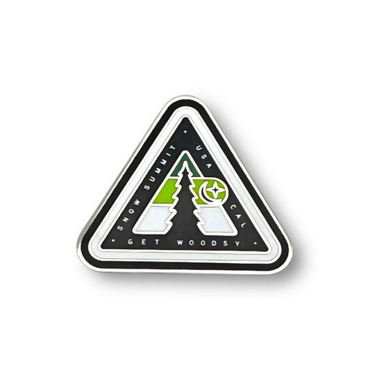 Woodsy logo on a pin with green coloring