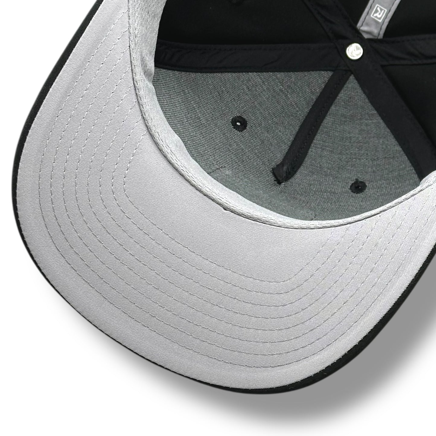 The gray under brim of a black hat, with black brim and gray with black lining.