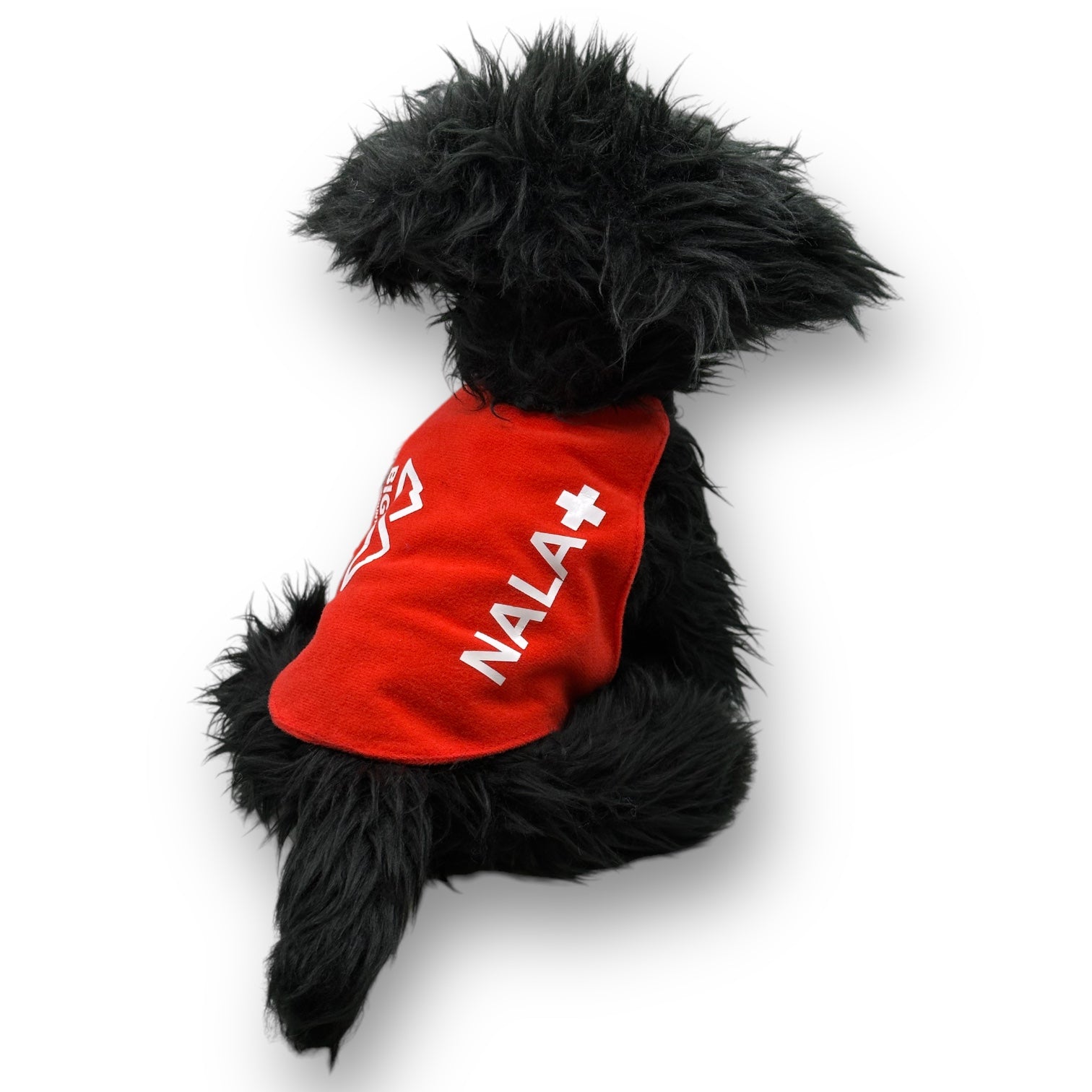 Backside of plush black dog with red patrol vest and the name, Nala