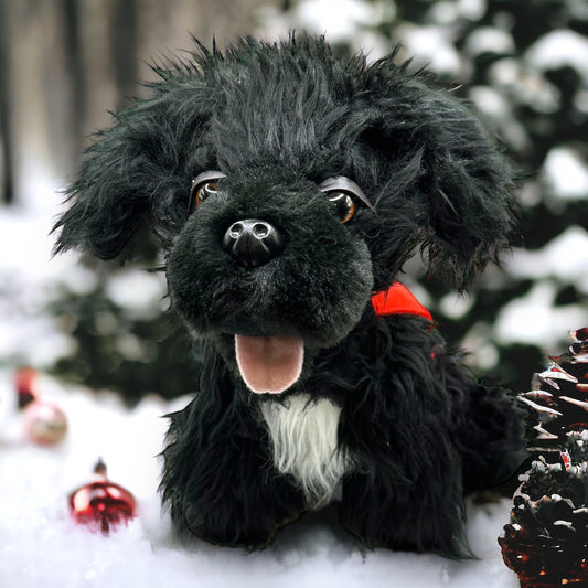 Plush black dog with red patrol vest and white fur spot on chest