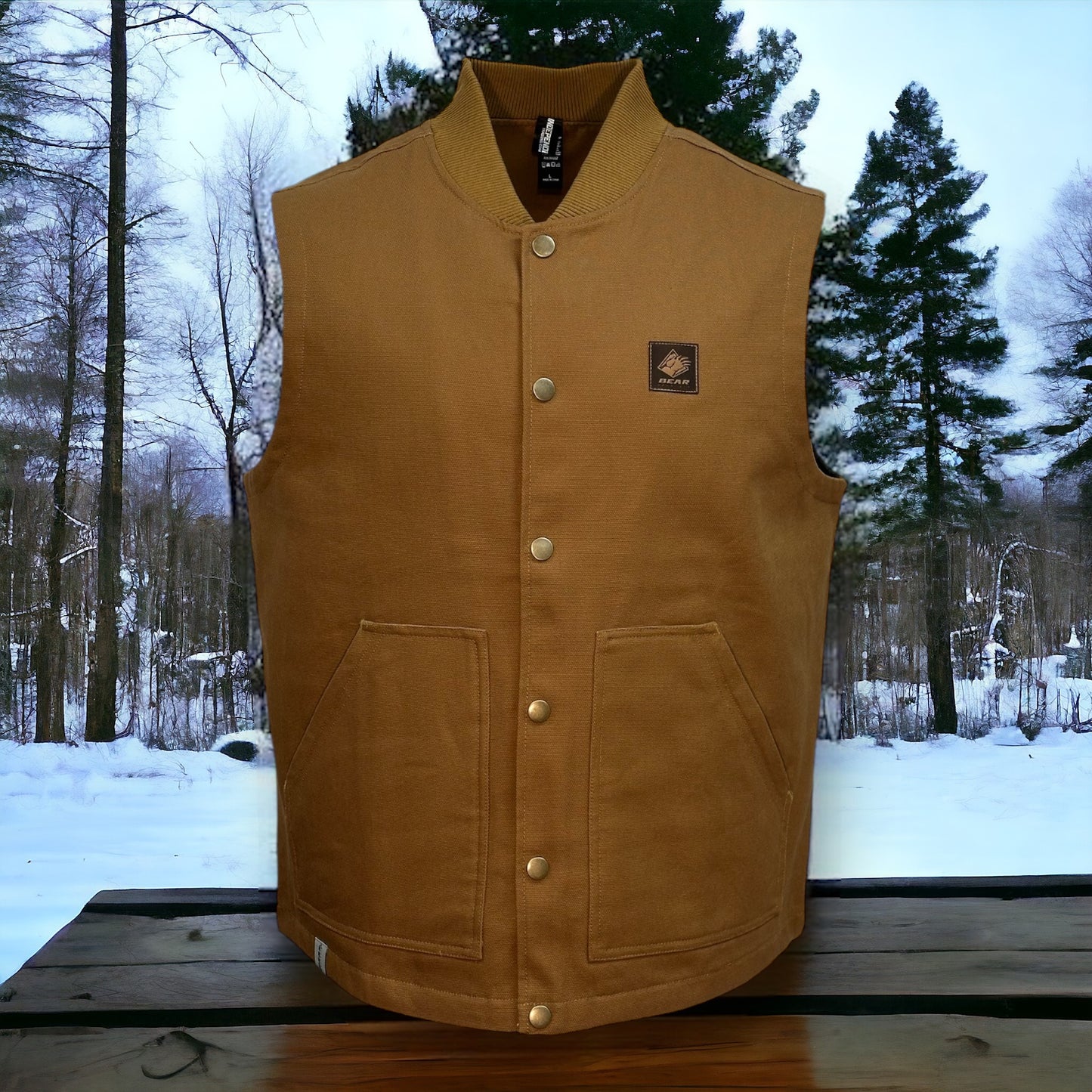 Brown button up vest with two large pockets on each side and a brown bear mountain patch on upper left side