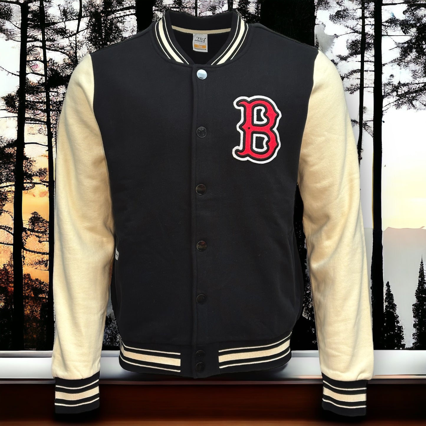 Front view of black letterman jacket with almond colored sleeves and a stitched letter B in red with black and white border