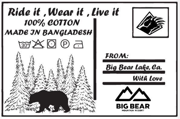 Internal t-shirt tag for Bear Mountain that resembles a postcard with the words: Ride it, Wear it, Live it; 100% cotton; Made in Bangladesh; From Big Bear Lake, CA with love and the resort logos with a bear and forest trees design