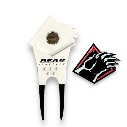 Golf divot tool with Bear Mountain words in black and a removable ball marker bear claw in red, white, and black.