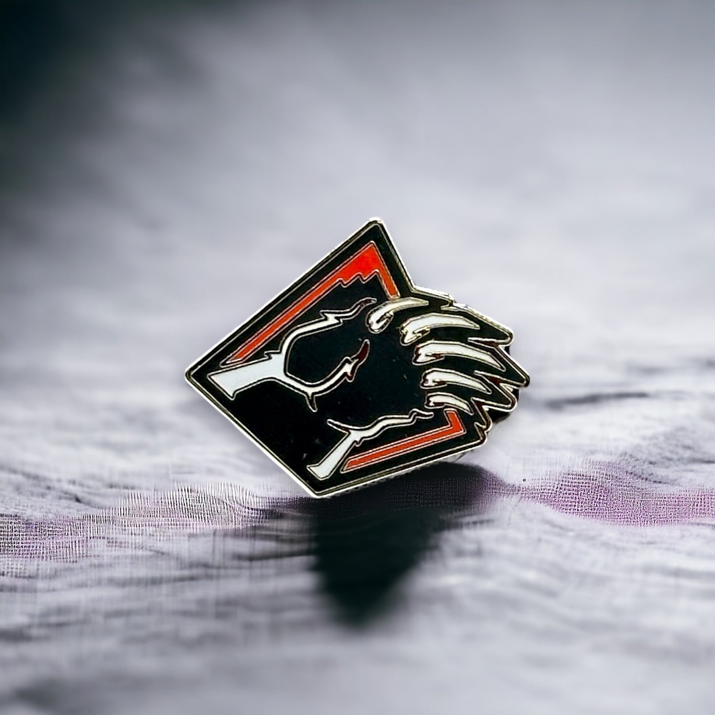 Bear Mountain bear claw metal pin in red black and white.