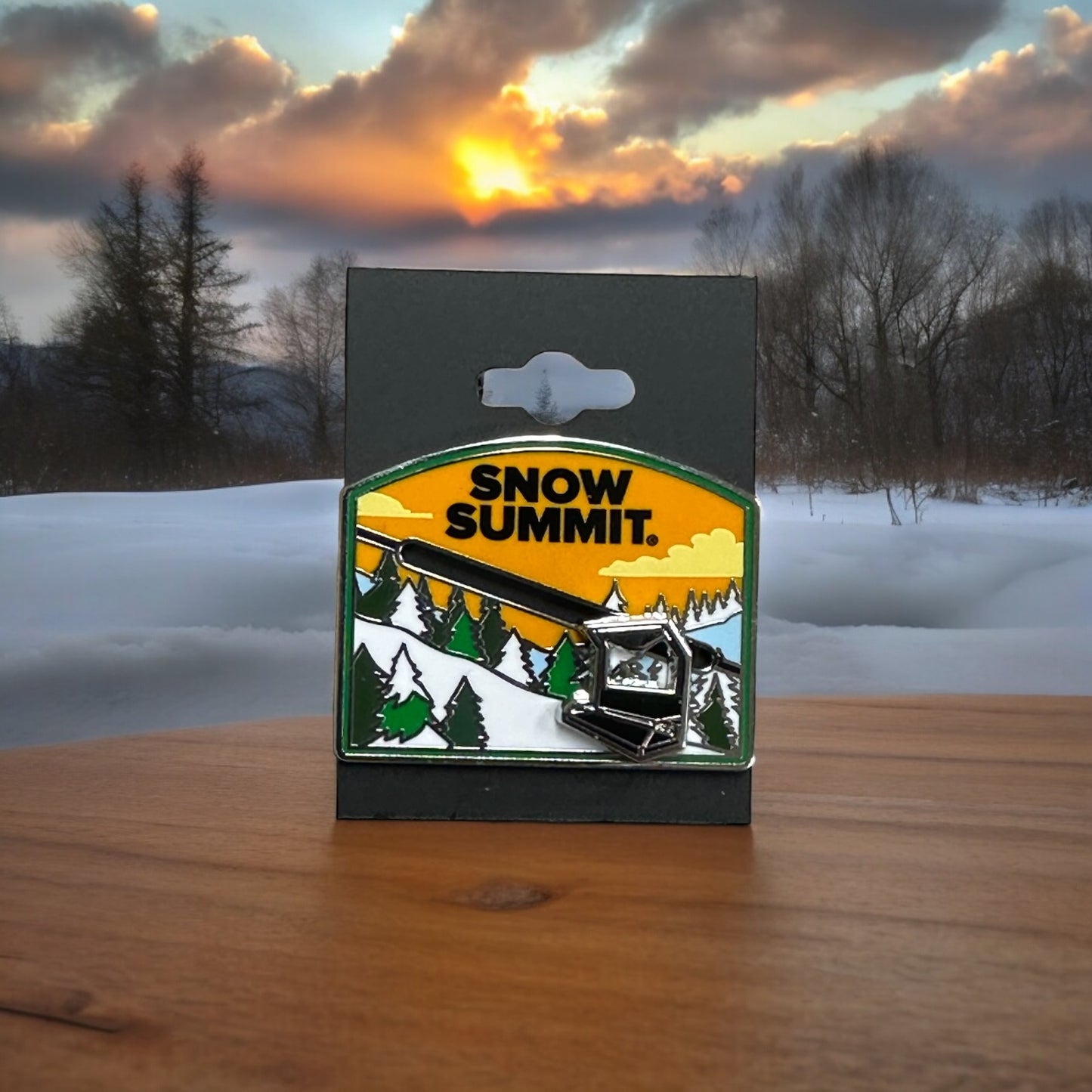 Snow Summit moving chairlift metal pin with a mountain scenery with green pine trees and a orange sky with white clouds