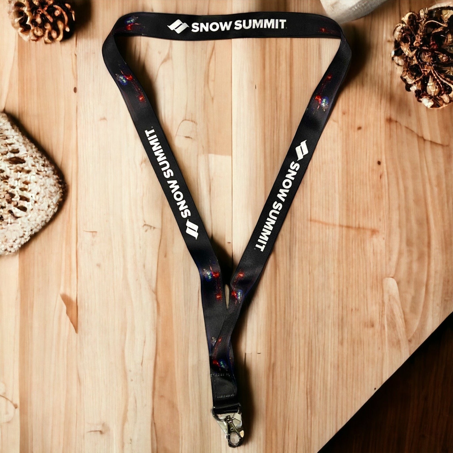 Black lanyard with white Snow Summit lettering and firework design.