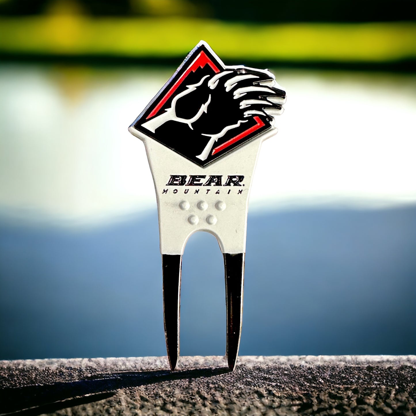 Bear Mountain bear claw divot tool with the Bear Mountain signature logo in red, white, and black with removable bear claw ball marker.