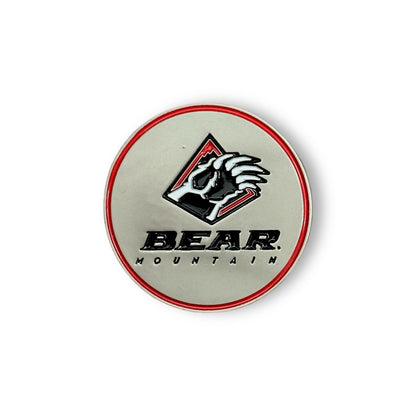 Bear Mountain golf ball marker in silver with red outlined edge and the Bear Mountain logo with bear claw emblem in the middle.