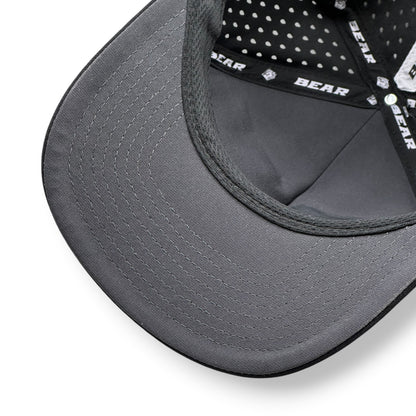 Close-up of a gray cap with mesh back and visible Bear branding on inside of hat.