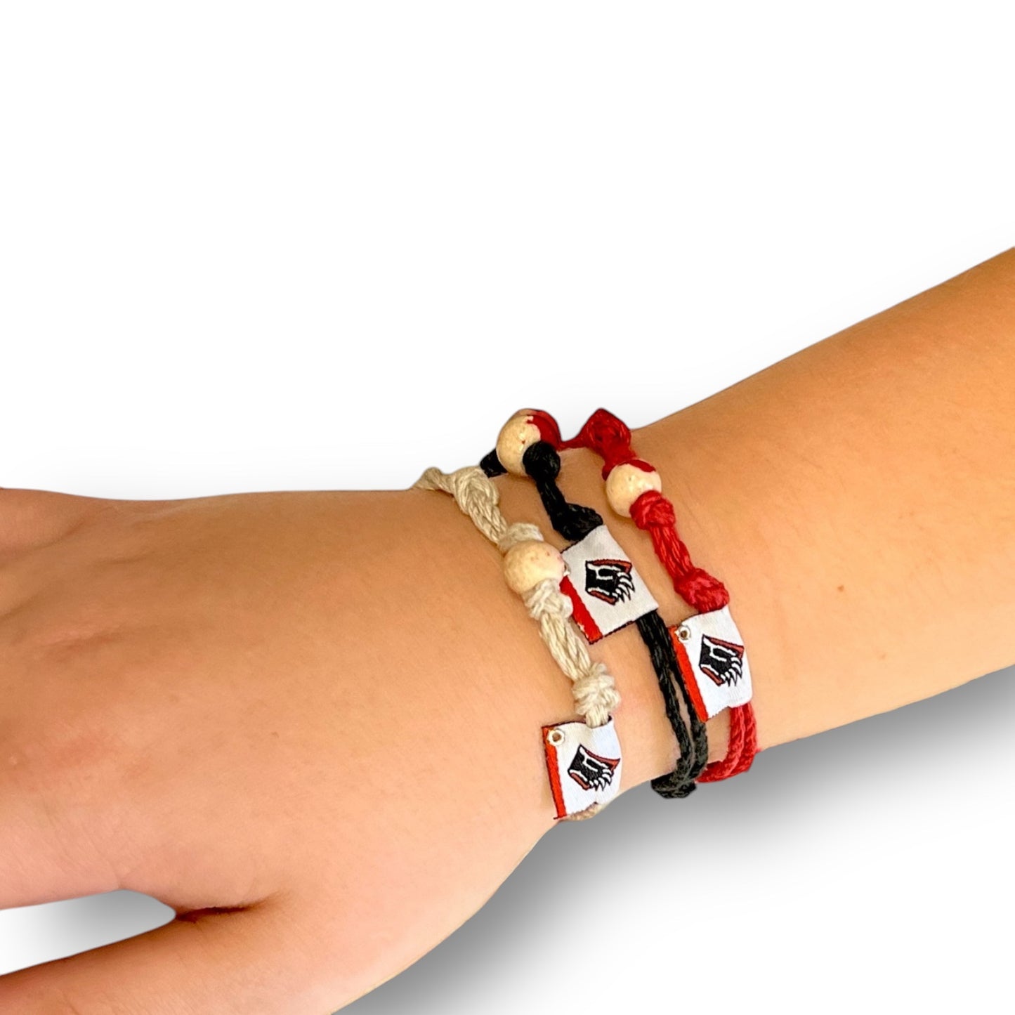 ECO-Friendly Earth Bands made of hemp. Black, red, and white roped bracelets with bead and Bear claw logo.
