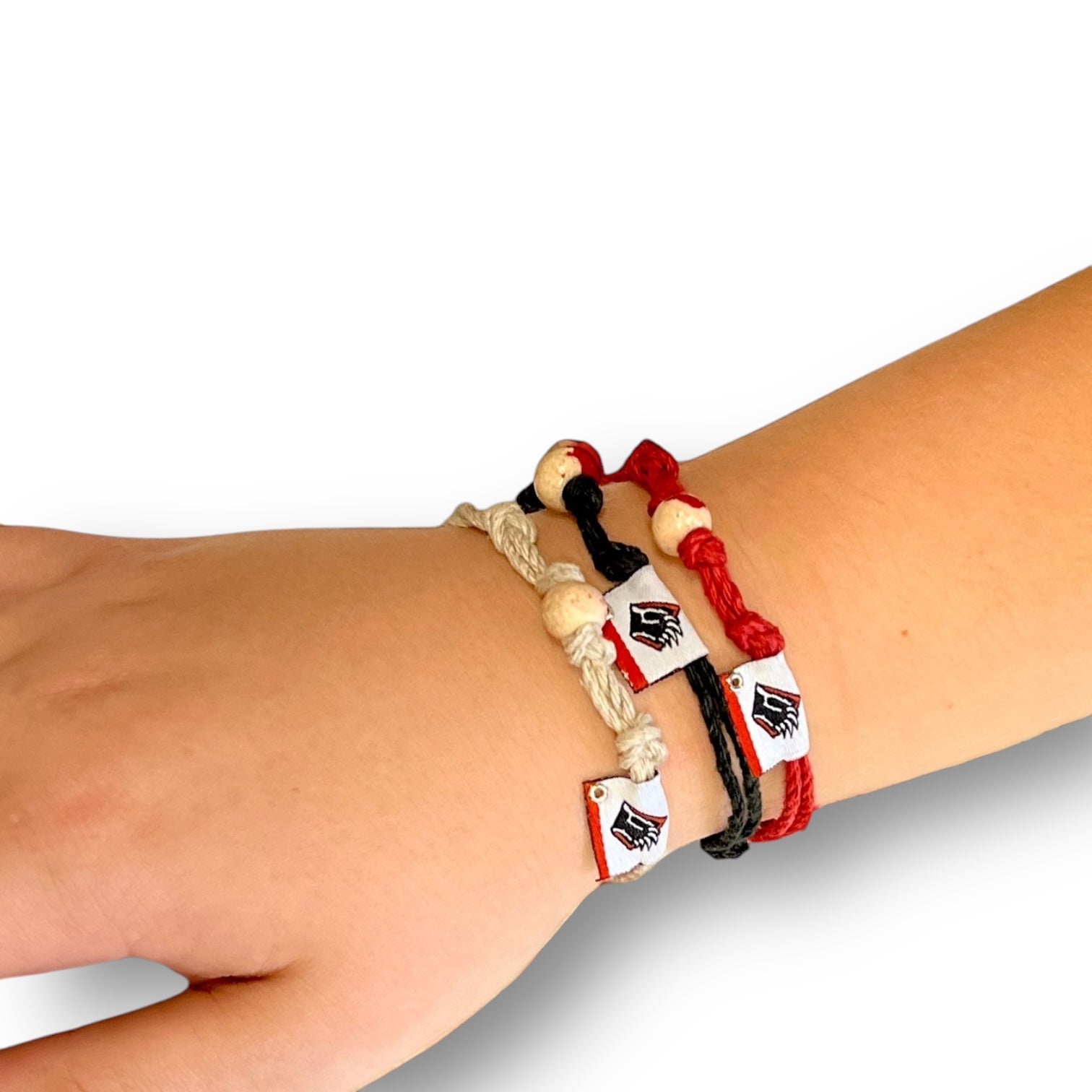 ECO-Friendly Earth Bands made of hemp. Black, red, and white roped bracelets with bead and Bear claw logo.