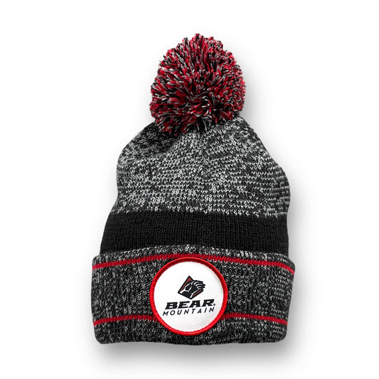 Beanie with pom on top, folded, that is red and black