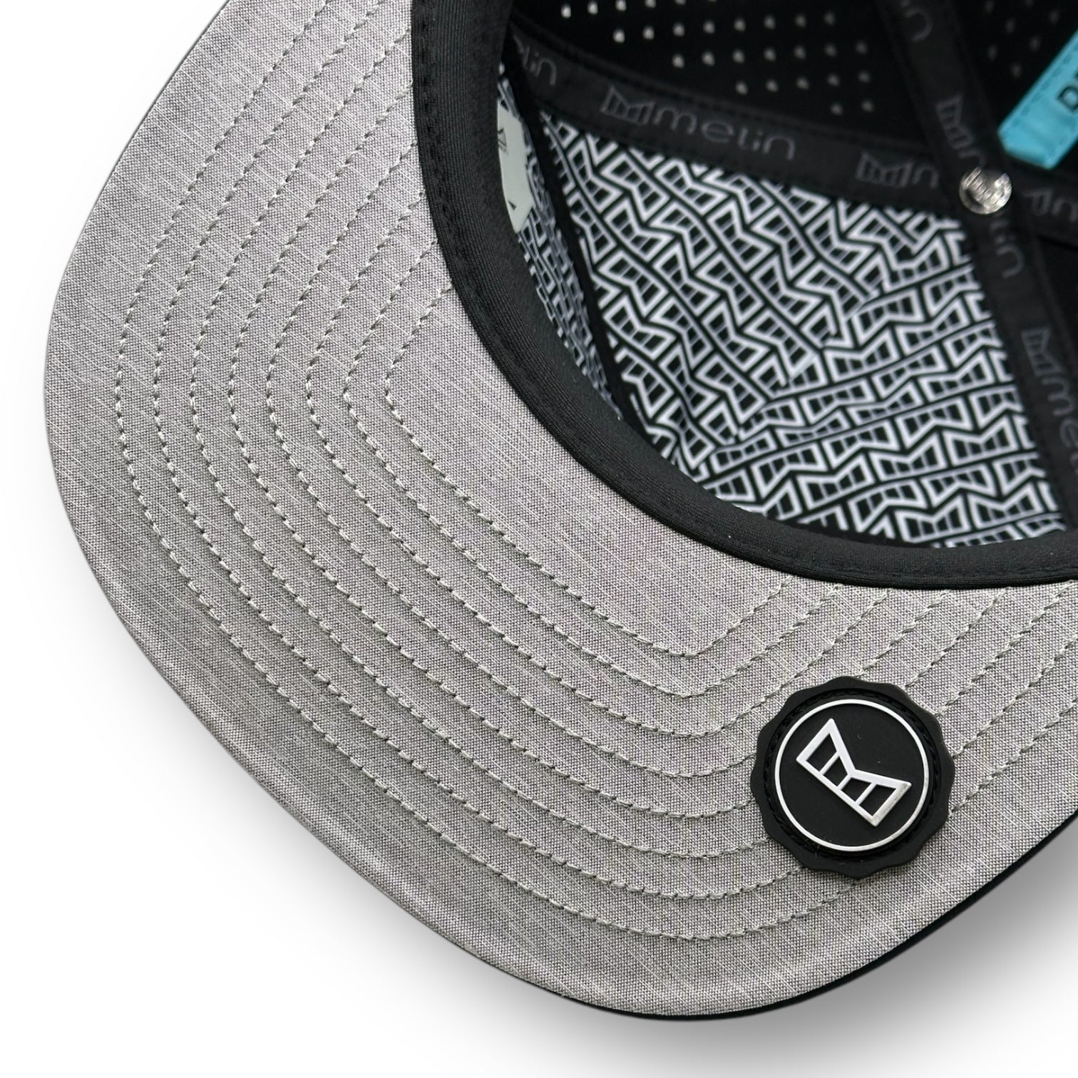 The underside of a Melin brand hat with the thumbprint undervisor seal.