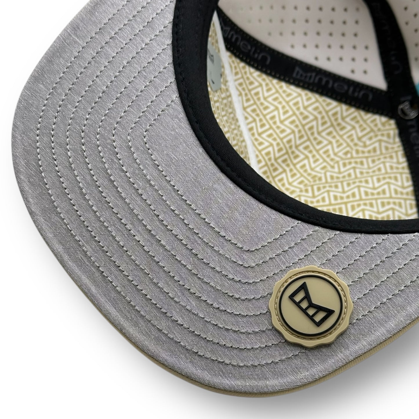 The underside of a Melin brand hat with the thumbprint undervisor seal.