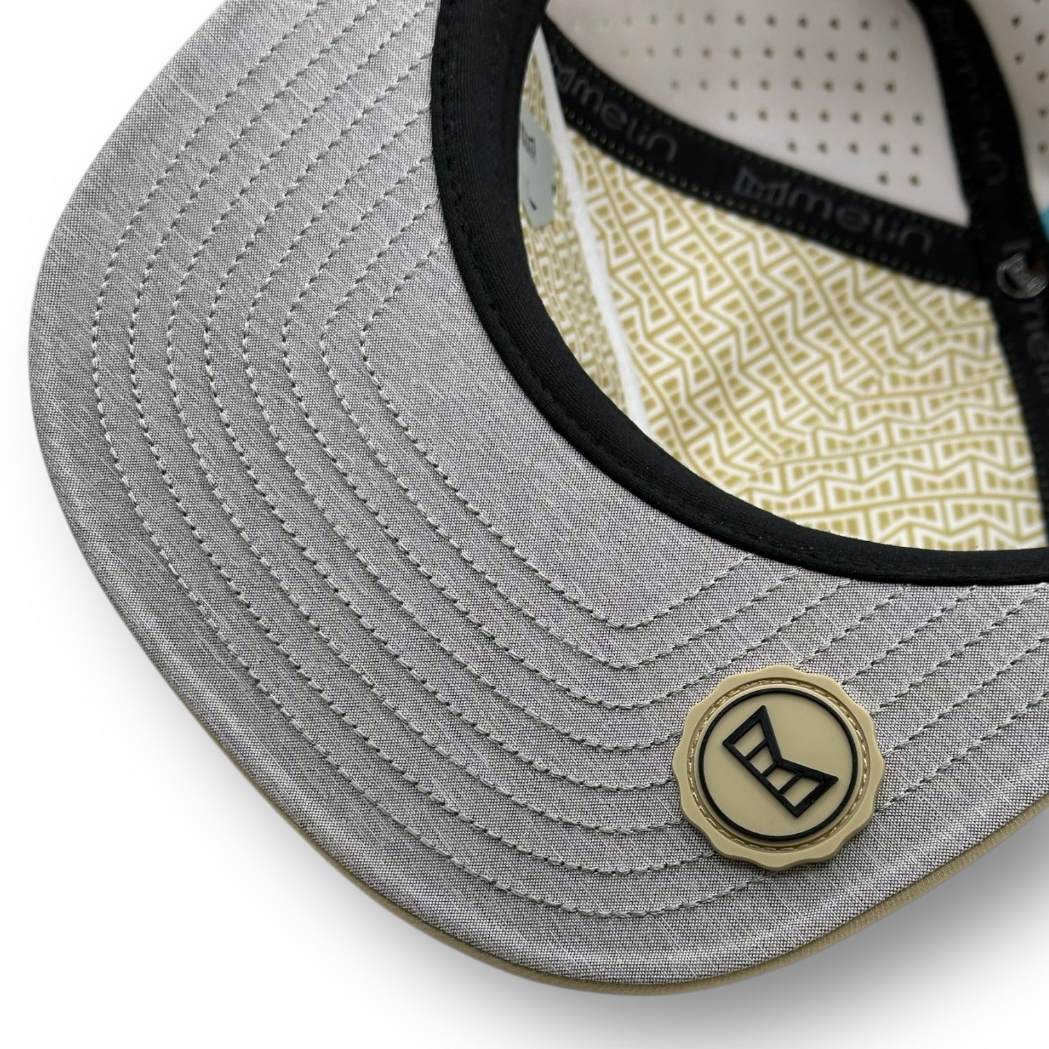 The underside of a Melin brand hat with the thumbprint undervisor seal.
