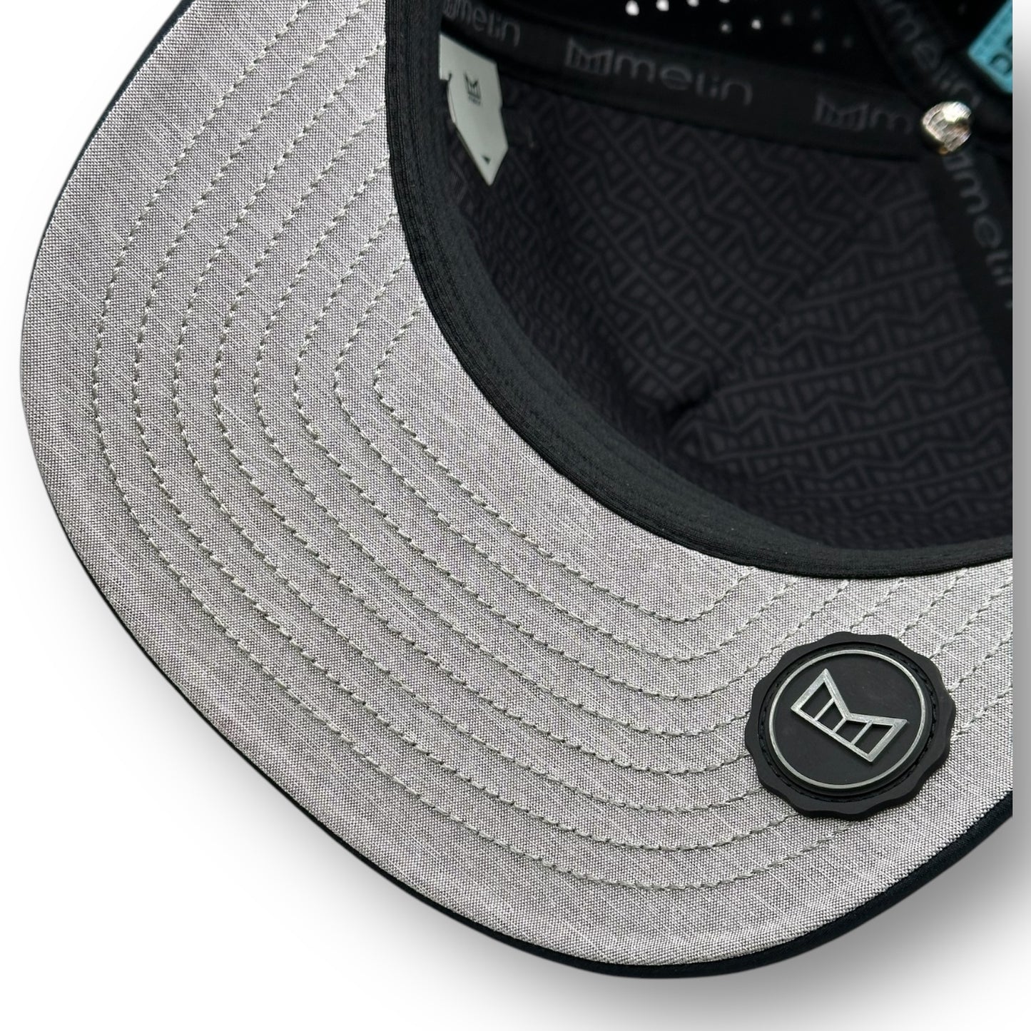 The underside of a Melin brand hat with the thumbprint undervisor seal.
