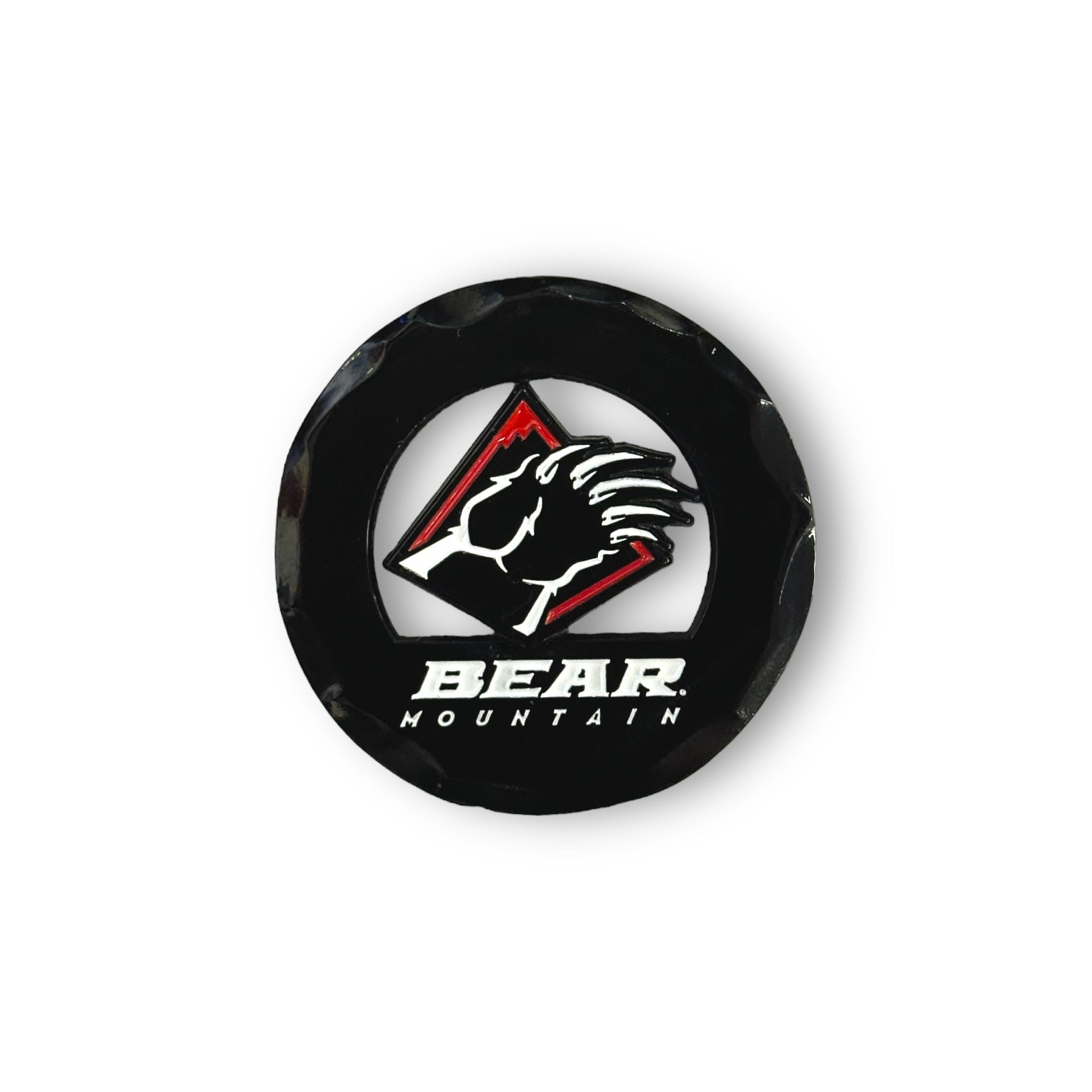 Black circular golf ball marker with the Bear Mountain bear claw logo in red and white.