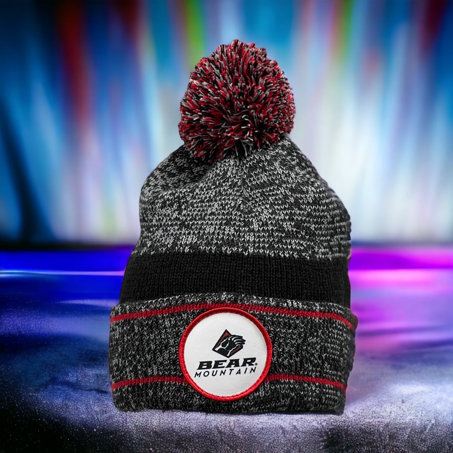 Beanie with pom on top, folded, that is red and black