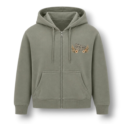 A sage green zip-up hoodie shown from the front. The front features a small 'Big Bear Rodeo' graphic on the left chest surrounded with flowers.