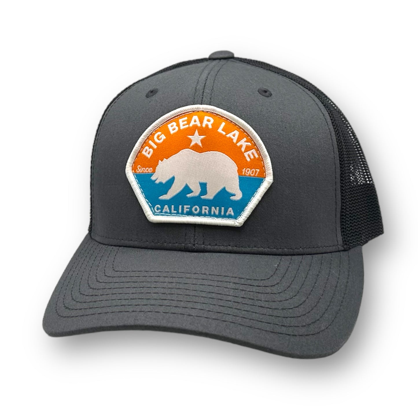Orange and blue themed logo with a bear on a grey trucker hat