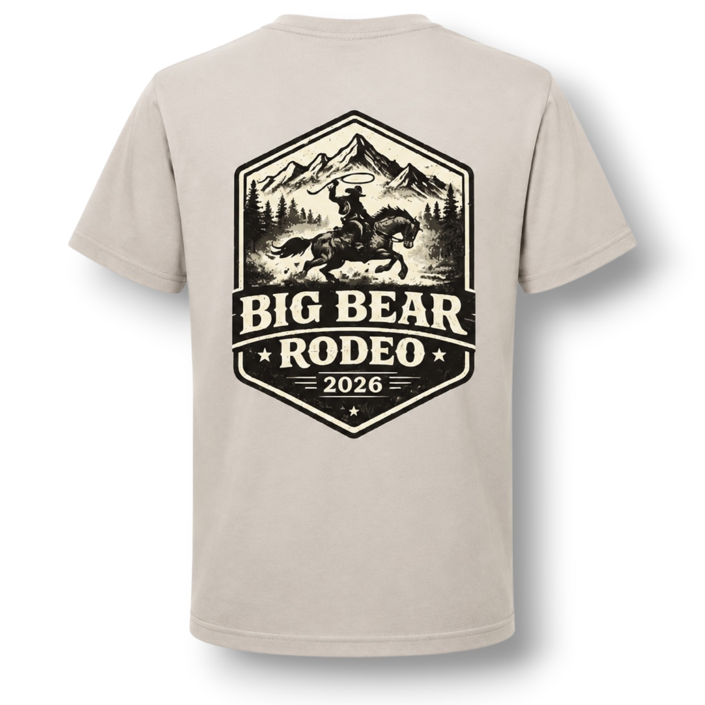 A light color crewneck t-shirt featuring a large black graphic print on the back. The graphic depicts a cowboy riding a bucking horse in front of mountains, with the text 'BIG BEAR RODEO 2026'.