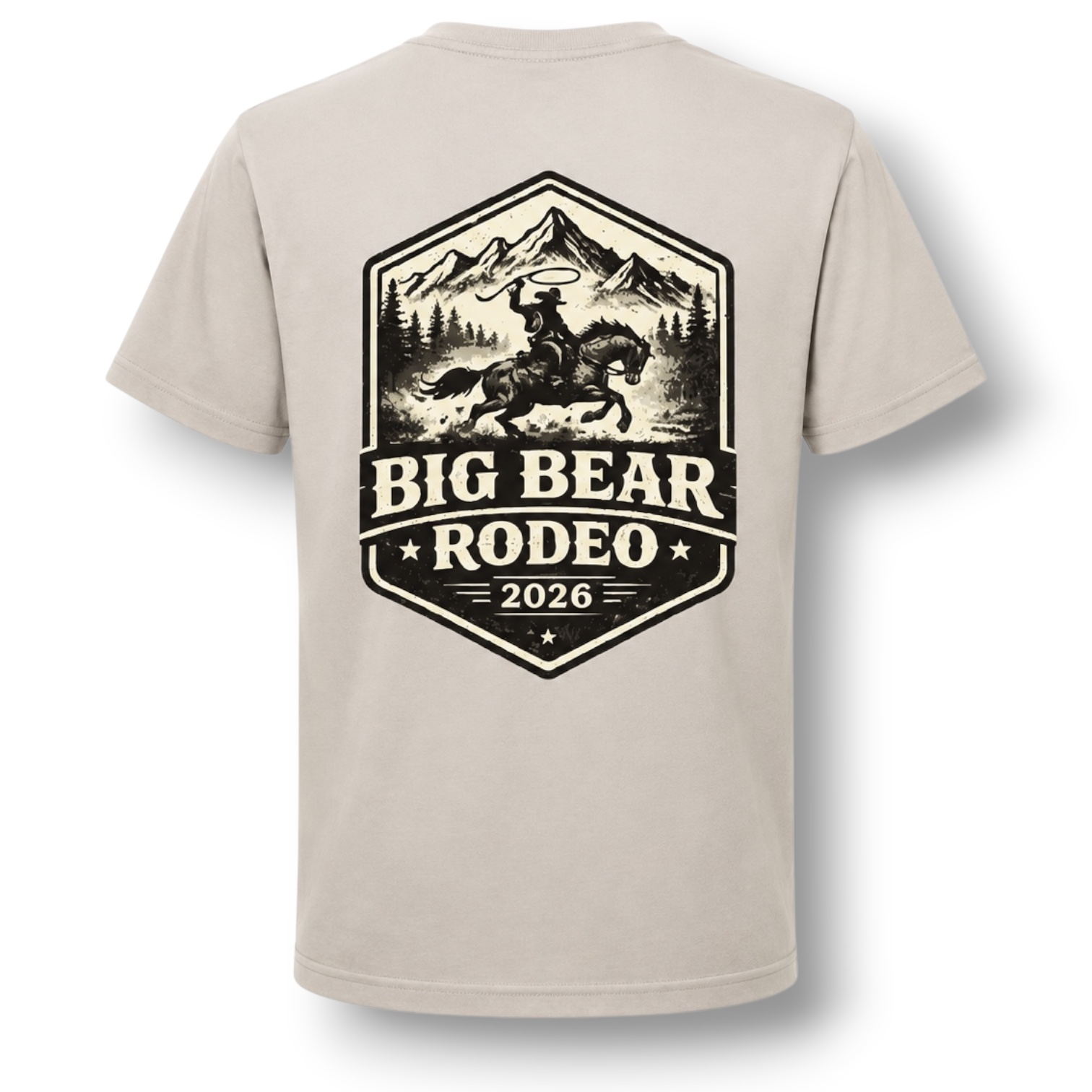 A light color crewneck t-shirt featuring a large black graphic print on the back. The graphic depicts a cowboy riding a bucking horse in front of mountains, with the text 'BIG BEAR RODEO 2026'.