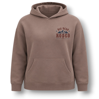 A hazy pink dusty brown pullover hoodie with a front pocket and a 'Big Bear Rodeo' graphic printed on the left chest, shown on a plain white background.