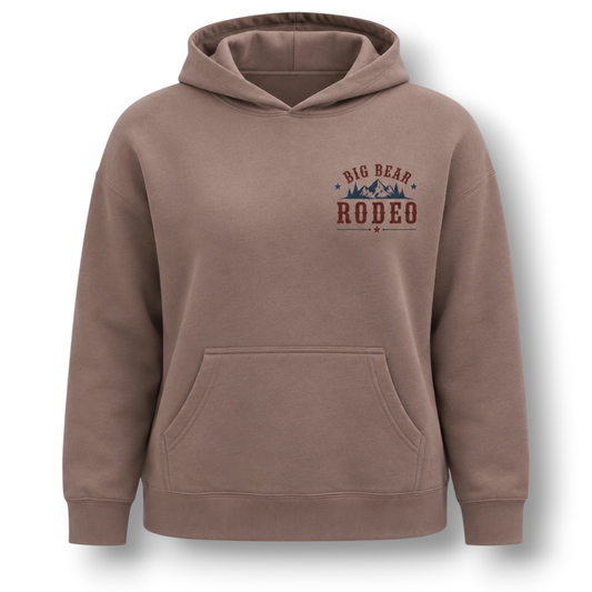 A hazy pink dusty brown pullover hoodie with a front pocket and a 'Big Bear Rodeo' graphic printed on the left chest, shown on a plain white background.