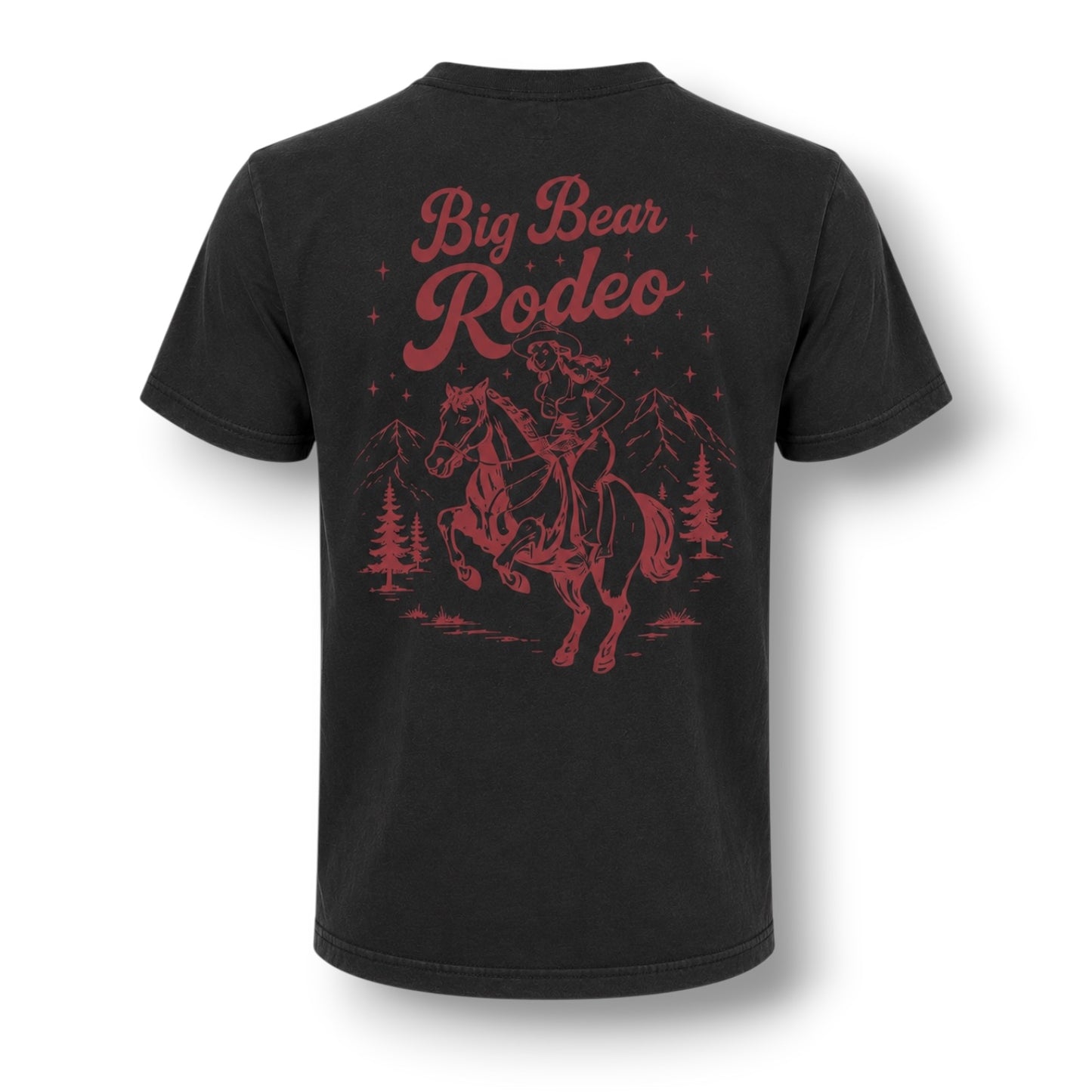 A black short-sleeve t-shirt shown from the back, featuring a dusty red graphic print of a cowboy riding a bucking horse under the words 'Big Bear Rodeo' with mountains and pine trees.