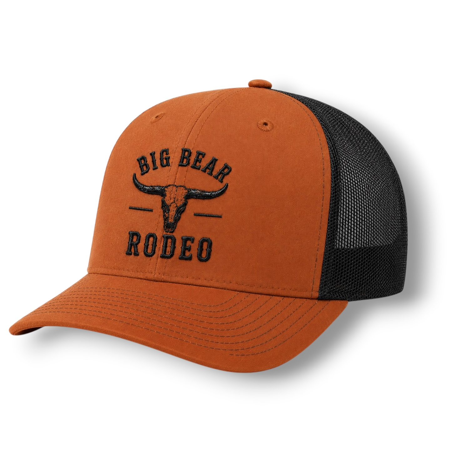 An orange hat with black back panels and a black embroidered 'BIG BEAR RODEO' bull skull logo on the front.