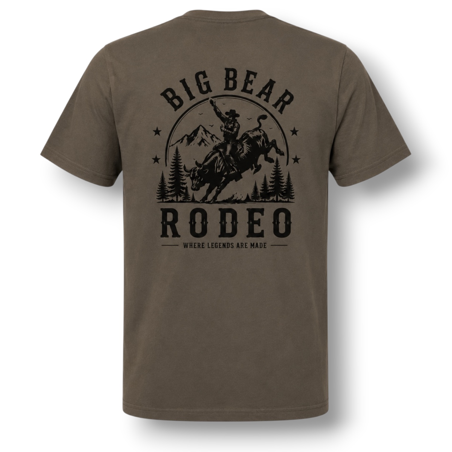 A dark color short-sleeve t-shirt with a black graphic print on the back featuring a cowboy riding a bucking bull in front of mountains and trees, with the text 'BIG BEAR RODEO' and 'WHERE LEGENDS ARE MADE'.