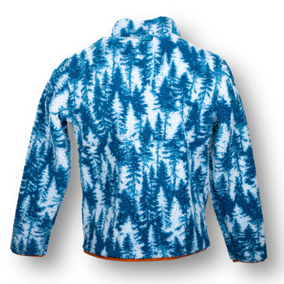 The back of a soft fleece jacket with orange lining and white and blue alpine tree design.