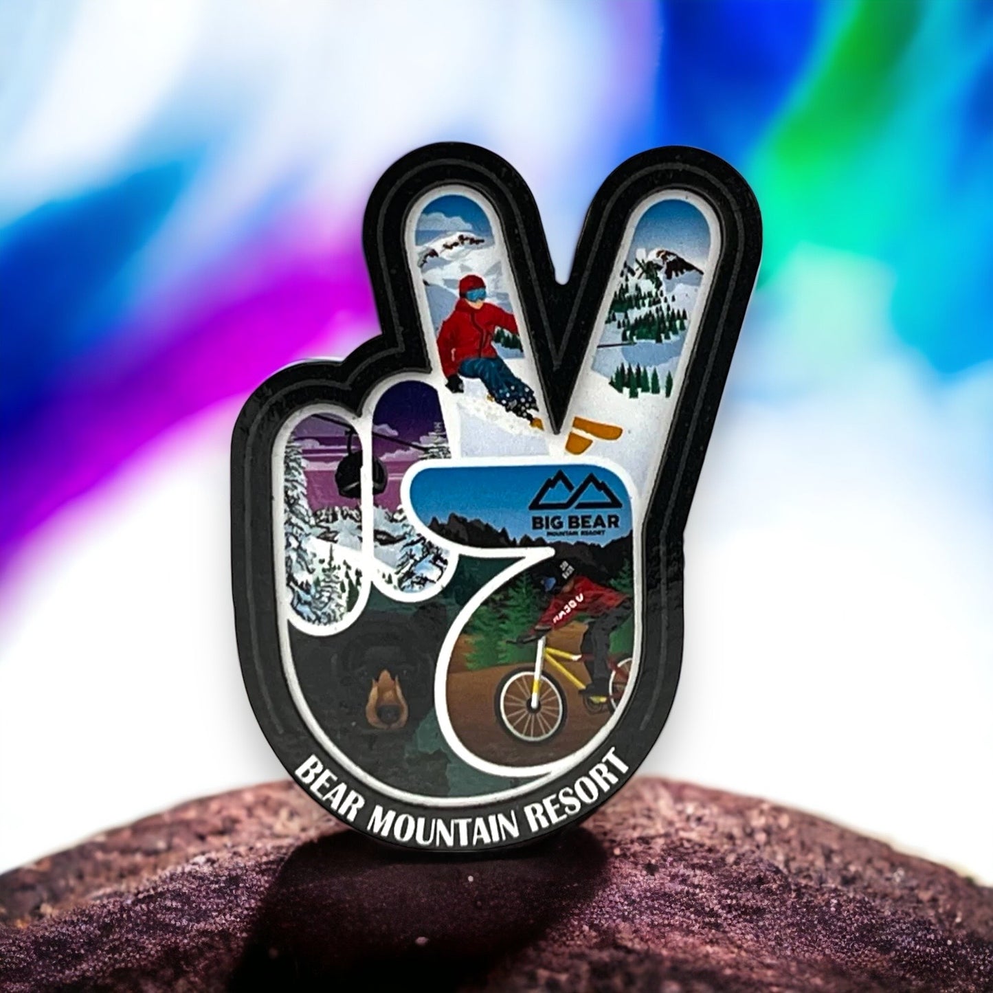 Hand peace sign shaped magnet with winter sports theme inside