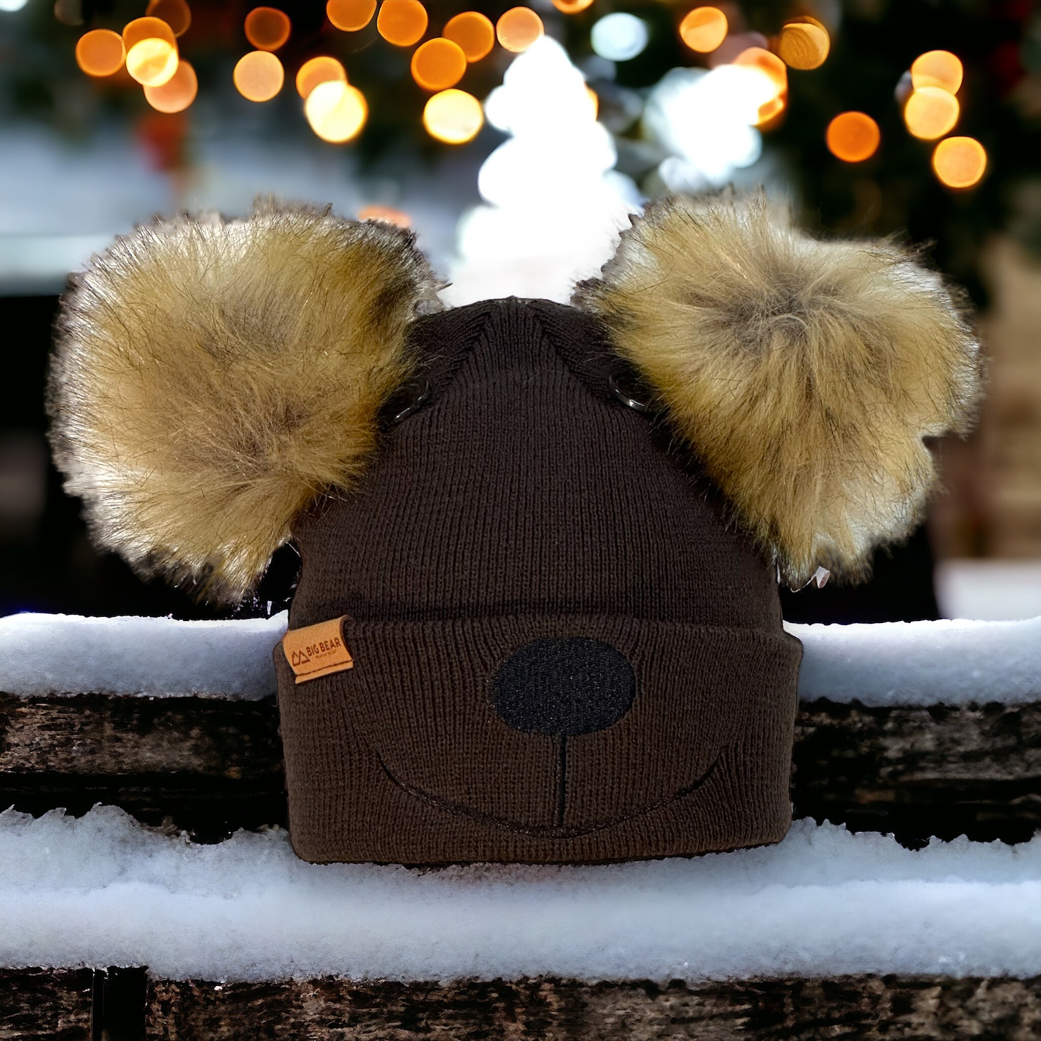 Beanie with nose and mouth stitching on cuff of beanie.  Two buttons as eye on crown of beanie.  Two fur pom poms on either side of top as ears and a BBMR patch on cuff.
