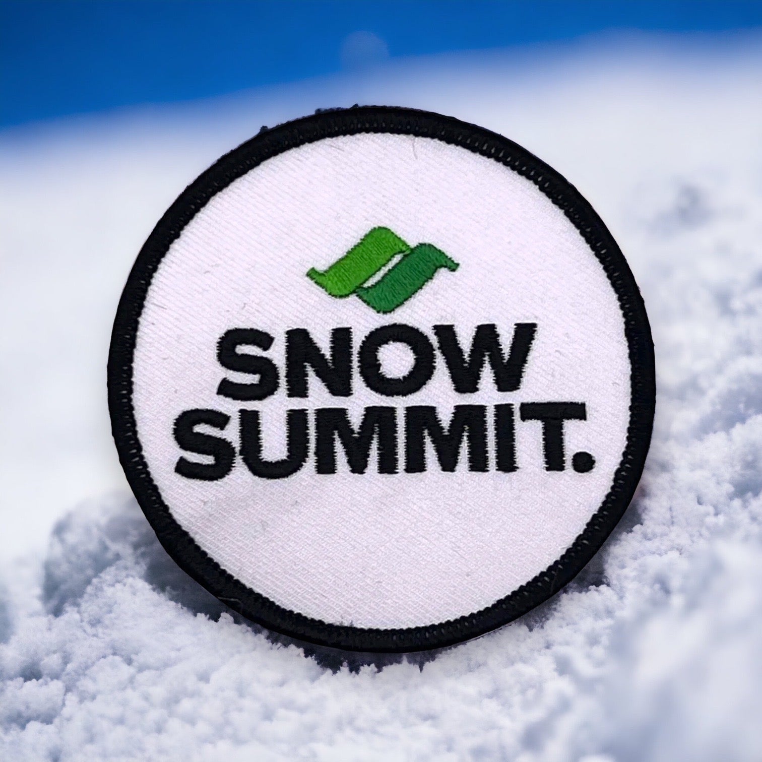 White patch with a snow summit logo stiched on it