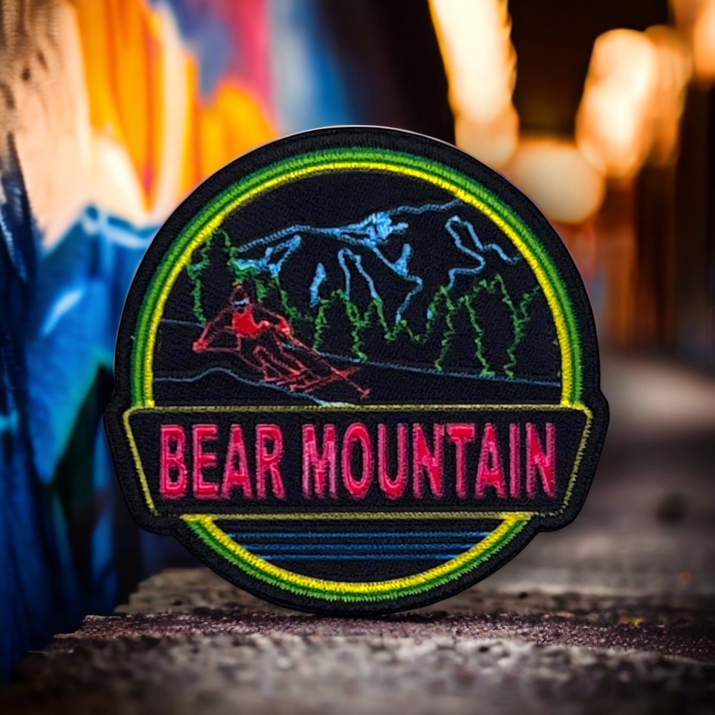 neon black and green patch with a bear mountain logo on it