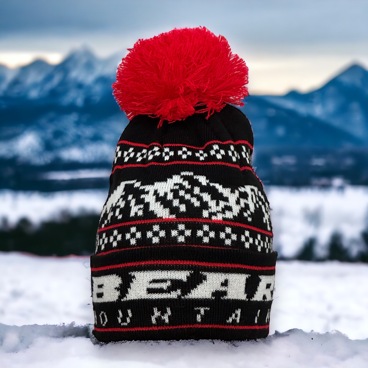 Black Beanie with white bear mountain stitching for the logo and red accent stitching with red pom pom at top