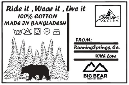 Internal t-shirt tag for Snow Valley that resembles a postcard with the words: Ride it, Wear it, Live it; 100% cotton; Made in Bangladesh; From Running Springs, CA with love and the resort logos with a bear and forest trees design