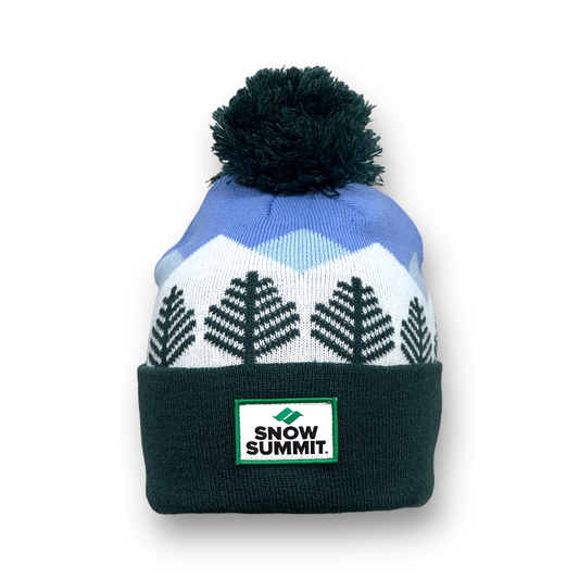Beanie portraying stitching of trees and a blue stitched sky with snow summit logo patch on cuff of beanie and dark green pom pom on top.
