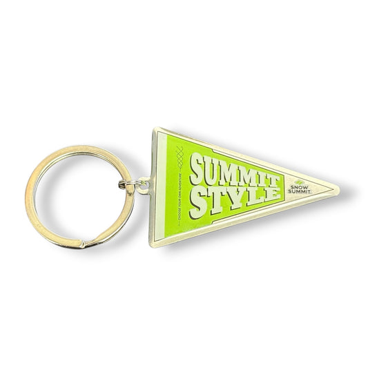 A triangular enamel pennant keychain with a gold-tone metal ring. The pennant is lime green with 'SUMMIT STYLE' printed in bold white letters with a black outline, and a small 'SNOW CLIMB' logo on the right side.