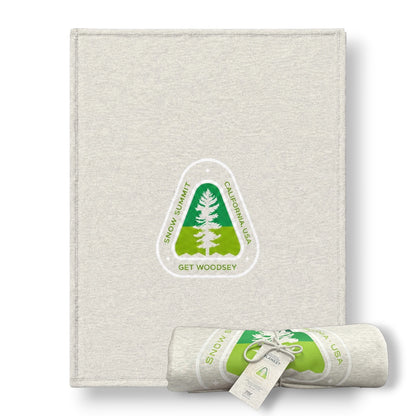 Snow Summit light grey sweatshirt blanket with a get woodsy green color tree logo.