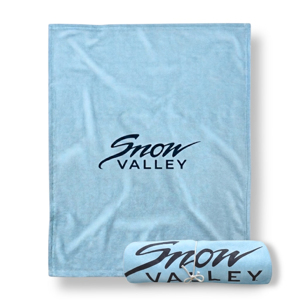 Light arctic blue blanket with Snow Valley logo in dark font.