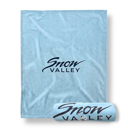 Light arctic blue blanket with Snow Valley logo in dark font.