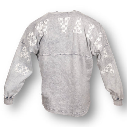 Backside of an oversized mineral wash crew neck long sleeve t-shirt with Snow Valley in white checker letters on the back, from arm sleeve to arm sleeve.
