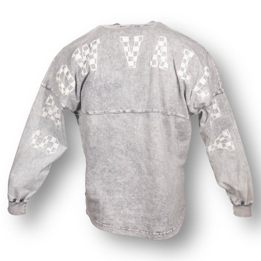 Backside of an oversized mineral wash crew neck long sleeve t-shirt with Snow Valley in white checker letters on the back, from arm sleeve to arm sleeve.