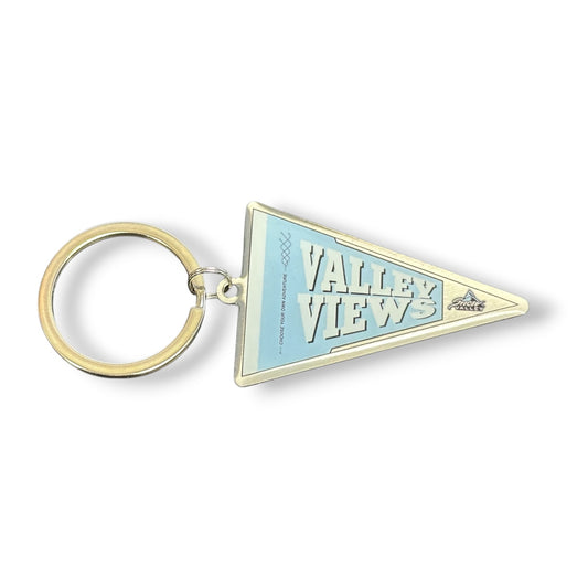 A triangular metal pennant keychain with a gold-tone split ring, featuring a light blue and white 'Valley Views' design on a white background.