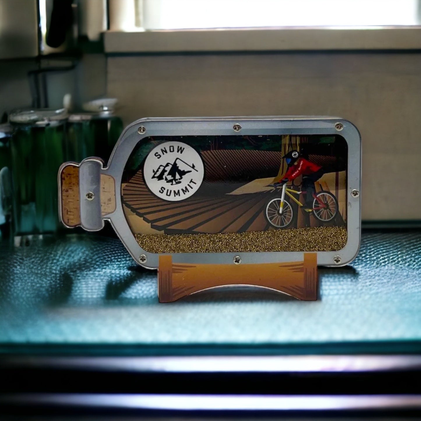 A magnet with a mountain biker in a bottle
